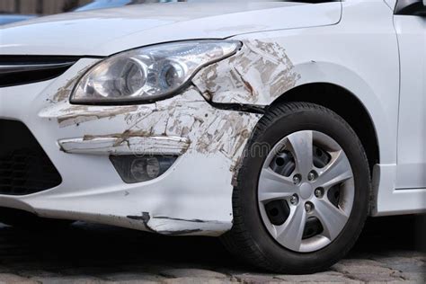 Dented Car With Damaged Fender Parked On City Street Side Road Safety