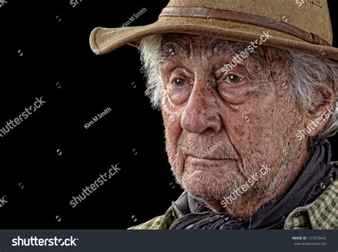 Grizzled Old Man Wearing A Tan Felt Hat Looking Pensive Stock Photo