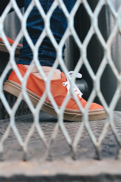 Person Wearing Orange Low Top Sneaker · Free Stock Photo