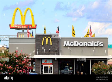 Golden Arches rises over a McDonalds drive-thru restaurant location in