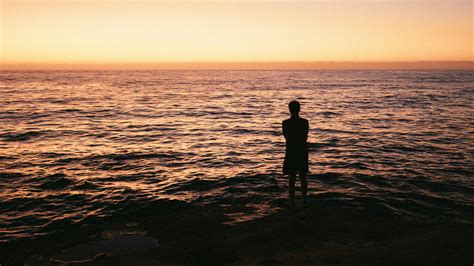 Silhouette Photo Of Man Standing On Seashore · Free Stock Photo