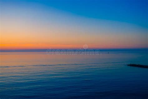 Sunrise Over A Quiet Calm Sea Stock Photo Image Of Morning Light