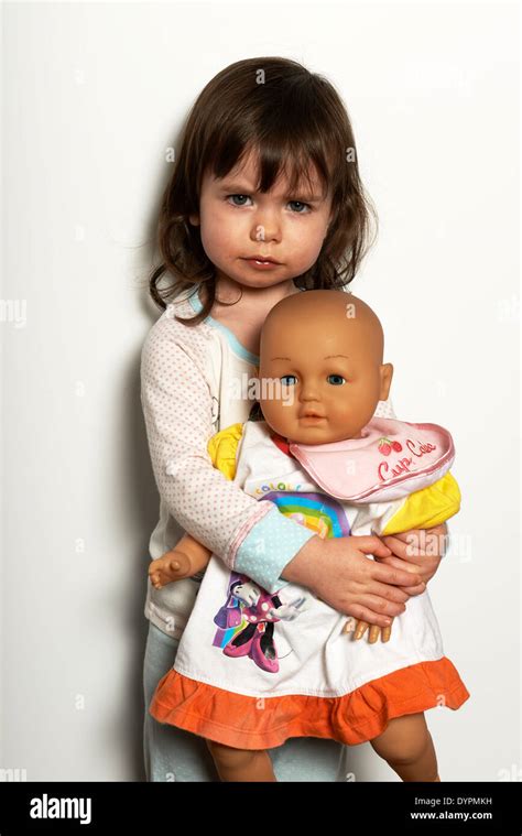 2 Year Old Girl Holding Doll Stock Photo Alamy