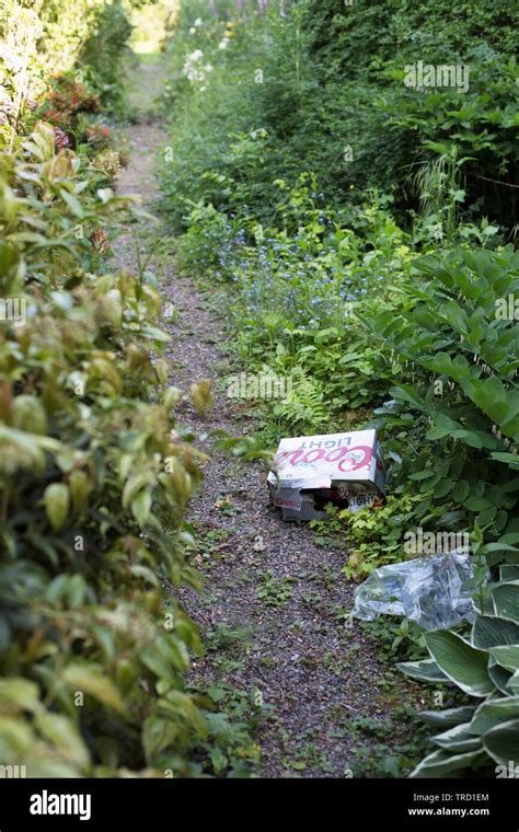 Litter On A Path In A Public Garden Stock Photo Alamy