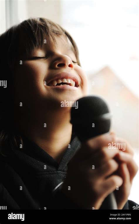 Musician Kid Singing With Microphone Stock Photo Alamy