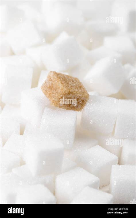 Close Up Macro Studio Shot Of A Brown Sugar Lump On White Sugar Cubes