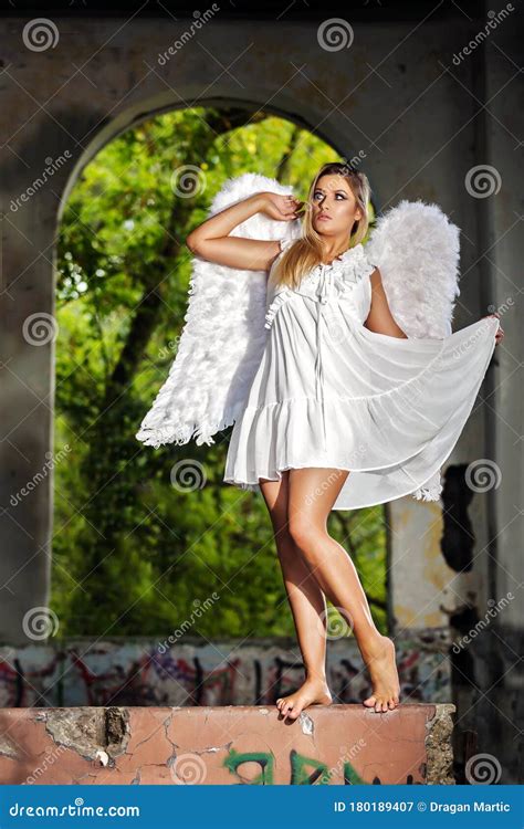 Portrait Of Beautiful Woman With White Angel Wings On Stock Image
