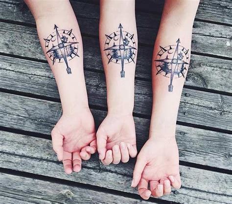 Two People With Matching Tattoos On Their Arms Holding Each Others
