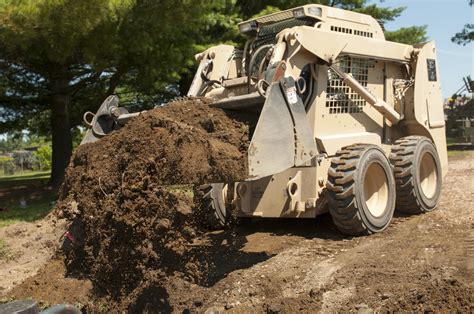A Soldier Uses A Skid Steer Loader To Bury A Polyvinyl Chloride Or Pvc
