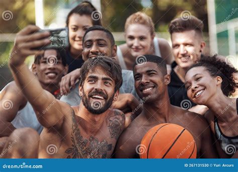 Just Hanging On The Court A Group Of Sporty Young People Taking Selfies Together On A Sports