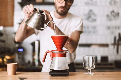 Close Up Photo Of Barista Standing At Counter And Preparing Pour Over