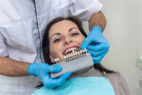 Doctor Compare Woman Teeth With Sampler In Dentistry Stock Image