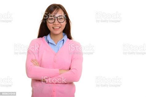 Young Happy Asian Teenage Girl Smiling And Wearing Eyeglasses With Arms