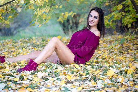Beautiful Woman Posing Sitting Ground In Autumn Park Stock Photo
