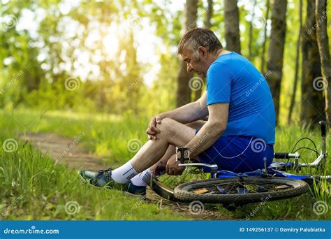 An Elderly Man Hurt His Leg While Riding A Bicycle Stock Image Image