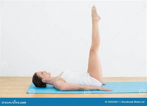 Smiling Woman Stretching Legs On Exercise Mat Stock Image Image Of Bare Years 35022847