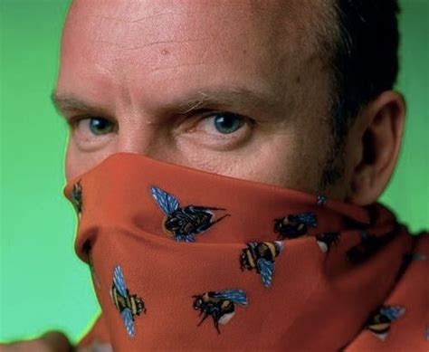 A Man Wearing A Red Scarf With Bees On It