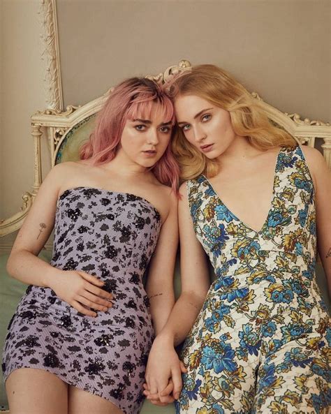 Two Women In Floral Dresses Posing For The Camera