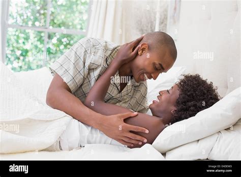 Intimate Couple Cuddling Lying On Their Bed Stock Photo Alamy