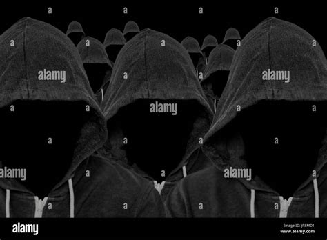 Mass of faceless mysterious and unknown hooded people with unseen faces