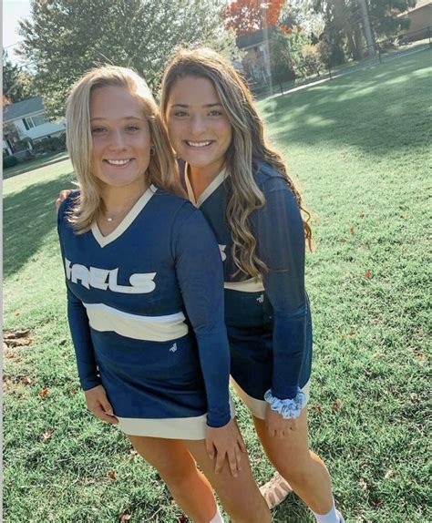 Two Girls In Cheer Uniforms Posing For A Photo