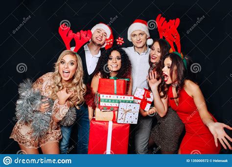 Group Of Funny Friends Laughing And Sharing Christmas Ts Friends Celebrating Christmas Or
