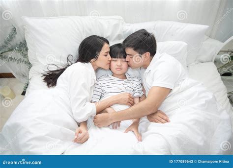Young Asian Mother Father And Boy Sleeping In Bed Mom And Dad Kiss On