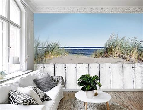 The Living Room Is Decorated In White And Has A Beach Scene Wall Mural