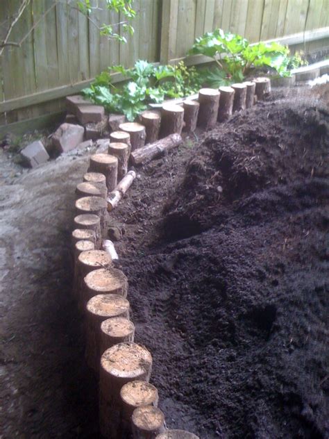 How to build a log garden wall. Log Retaining Wall | This little retaining wall was built ...