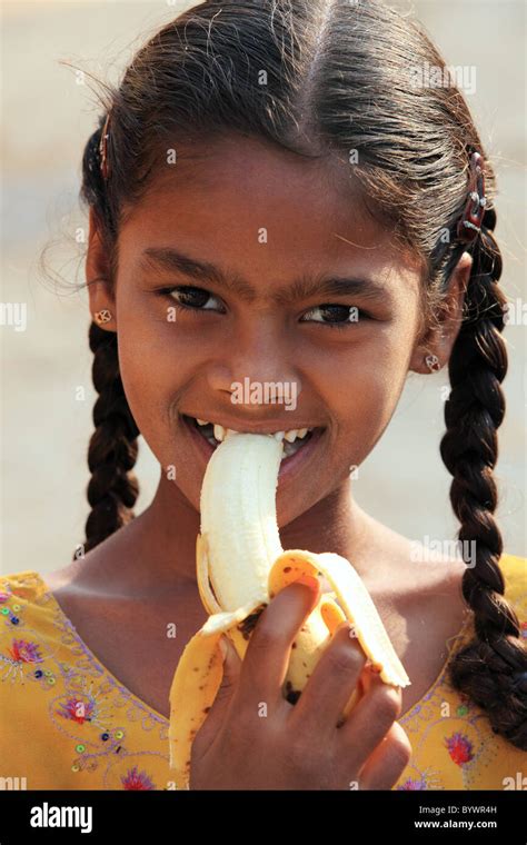 Girl Eating A Banana Andhra Pradesh South India Stock Photo Alamy