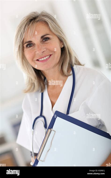 Portrait Of Smiling Senior Nurse In Hospital Stock Photo Alamy