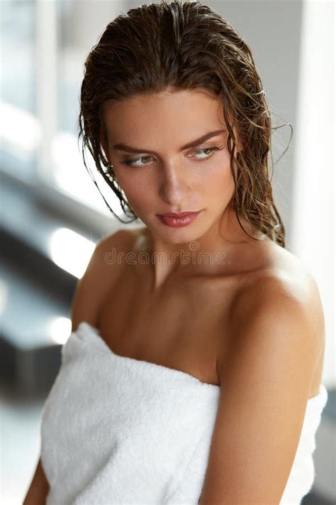 A Beautiful Woman With Wet Hair Looking At The Camera Generated By Ai