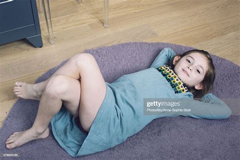 Girl Lying On Floor With Hands Behind Head Smiling Photo Getty Images