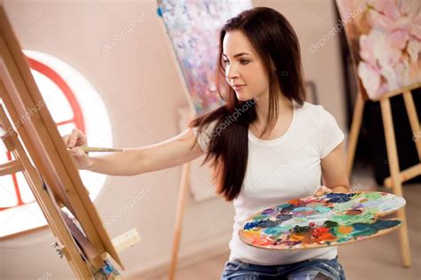Female Artist Working On Painting In Studio — Stock Photo © Bezzznika Fd3