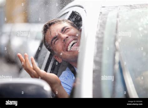 Enthusiastic Man In Car Looking Out Window At Rain Stock Photo Alamy