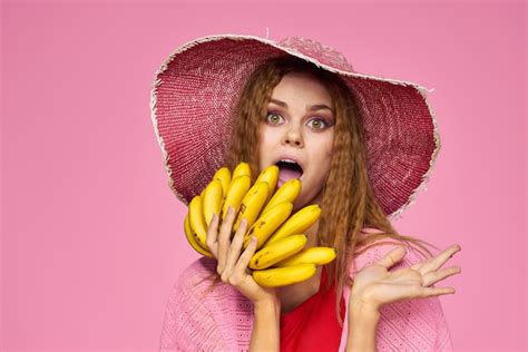 premium photo woman with bananas in hands in hat exotic fruits lifestyle pink background high