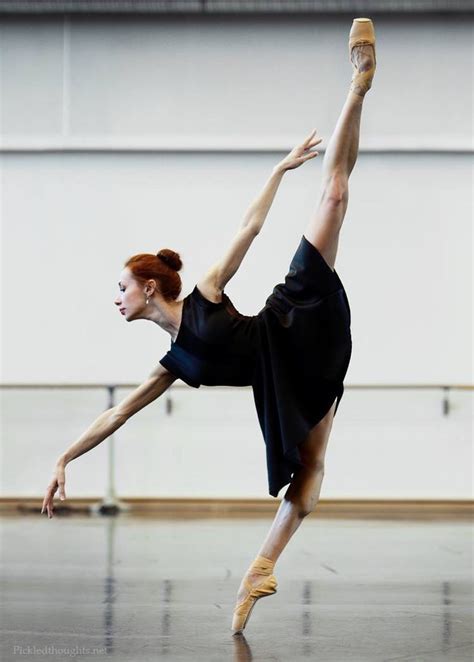 A Woman In Black Dress Doing A Ballet Move