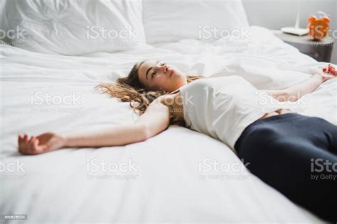 Beautiful Young Woman With Long Hair Sleeping On Bed In Bedroom Stock