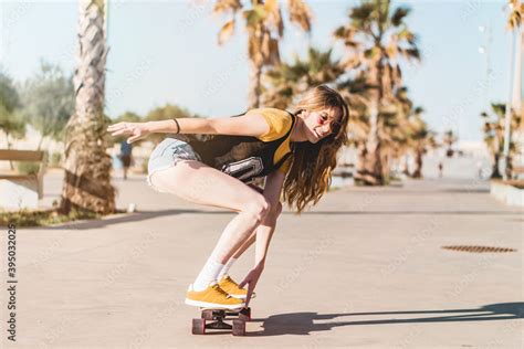 skater girl riding a long board skate cool female urban sports california style outfit woman