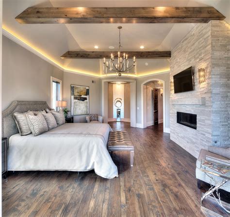 Master Bedroom Floor To Ceiling Stone Fireplace Hardwood Floor