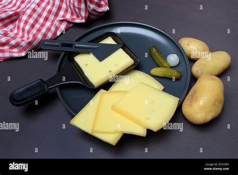 Raclette Cheese Slices In Raclette Pans Switzerland Europe Stock