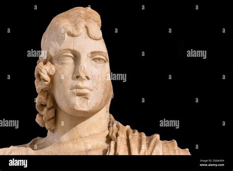 Close Up On Broken Face Of Ancient Roman Statue Of Long Haired Young