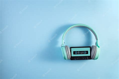 Premium Photo Turquoise Headphones With Audio Cassette On A Blue