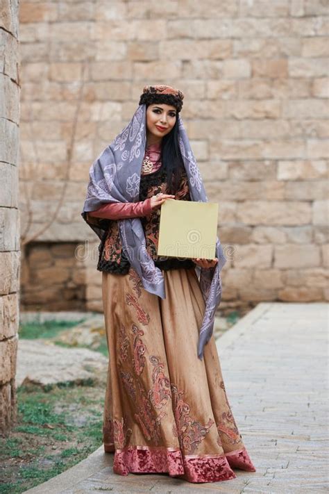 Young Azeri Woman In Traditional Azerbaijani Dress With Present Box In