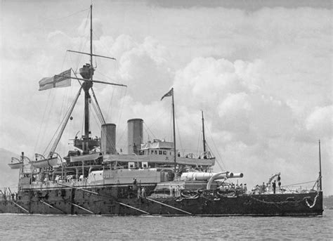 An Old Black And White Photo Of A Ship In The Water With Flags On It