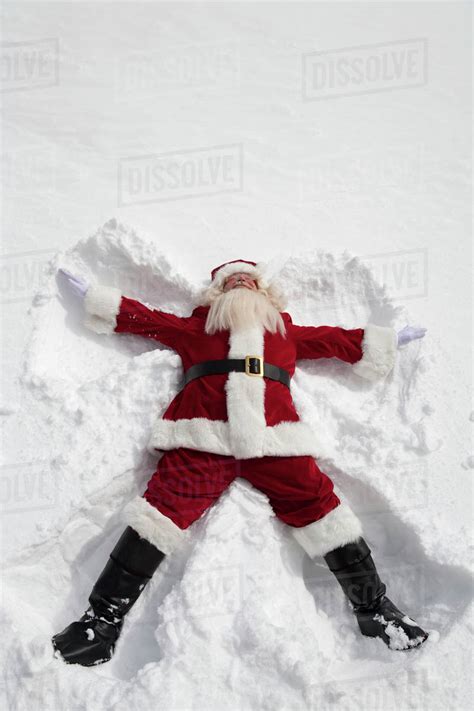 Santa Claus Making Snow Angel Outdoors Stock Photo Dissolve
