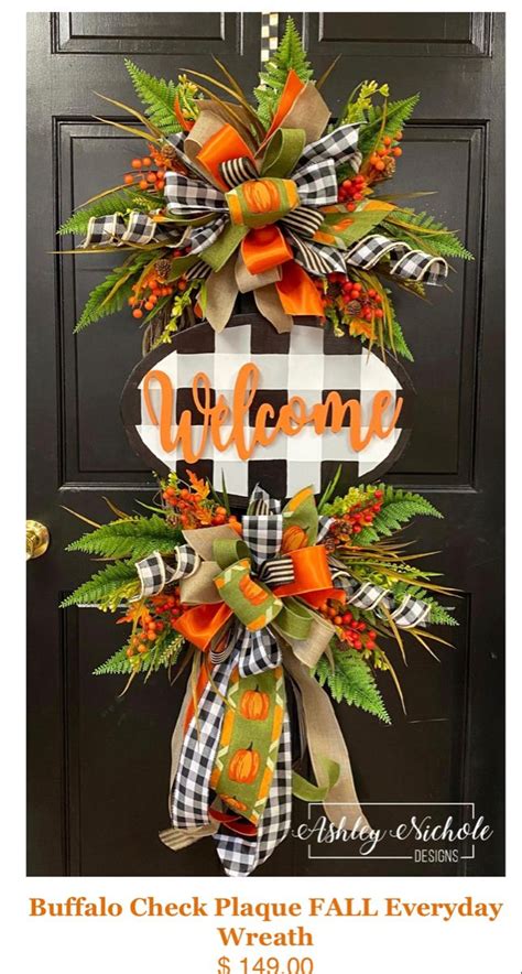 A Welcome Sign Hanging On The Front Door With Fall Foliage And Pumpkins