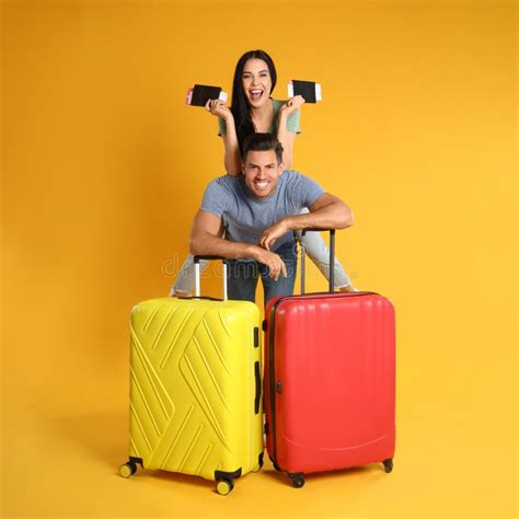 Couple With Suitcases And Passports For Summer Trip On Yellow Background Vacation Travel Stock