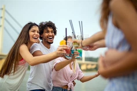 Happy Young People Friends Having Fun On The Beach And Drinking Cocktails Together Stock Image