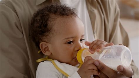 Baby Feeding Cute Little African American Baby Drinking Milk From Kid